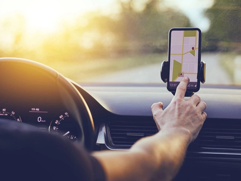 Person using smartphone for navigation while driving - 180 Degree Floors in the Nashville, TN area