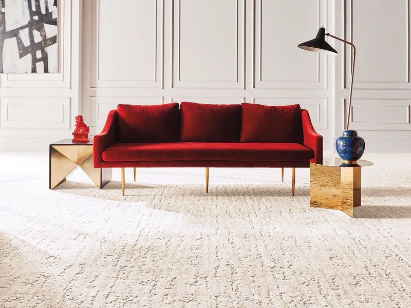 Bright living room with red velvet couch and beige textured carpet from 180 Degree Floors in the Nashville, TN area