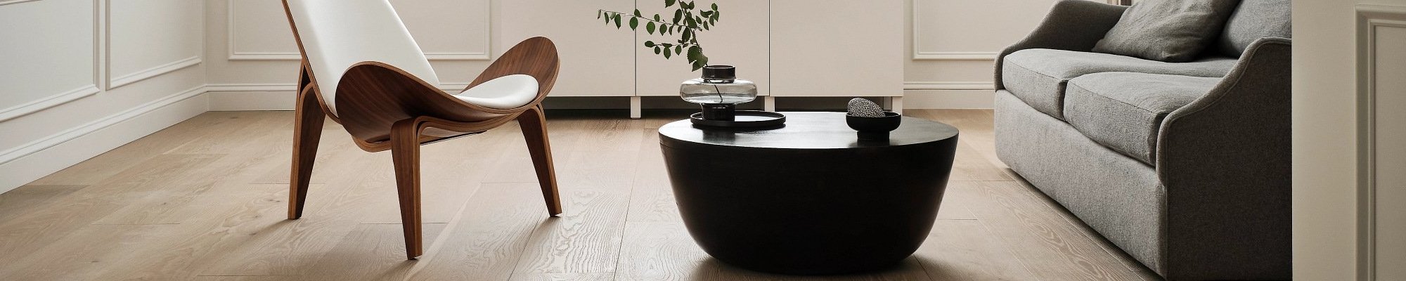 living room with hardwood floor and black coffee table with a plant on it in a glass vase from 180 Degree Floors in the Nashville, TN area